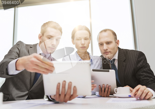 Image of business team with tablet pc having discussion