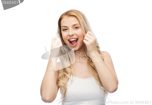 Image of happy young woman with dental floss cleaning teeth