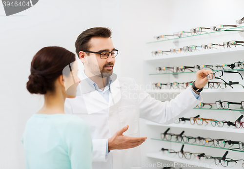 Image of woman and optician showing glasses at optics store