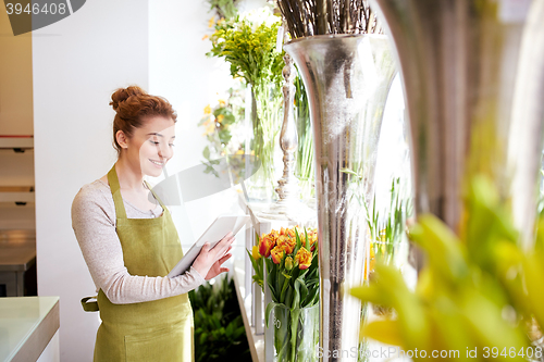 Image of woman with tablet pc computer at flower shop