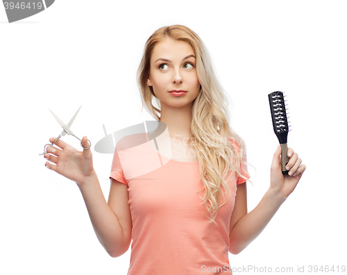 Image of young woman with scissors and hairbrush