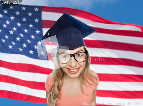 Image of smiling young student woman in mortarboard