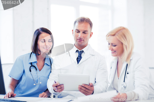 Image of doctors looking at tablet pc