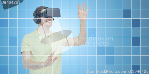 Image of happy man in virtual reality headset or 3d glasses