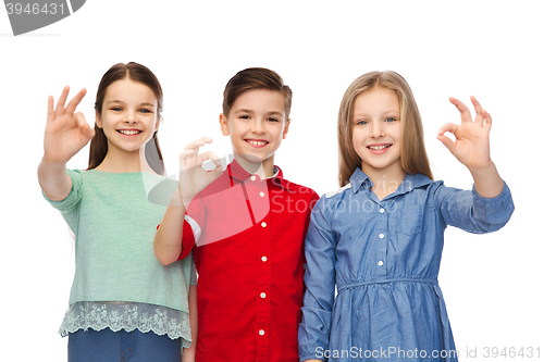 Image of happy boy and girl showing ok hand sign