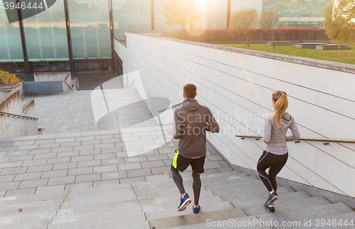 Image of couple running downstairs on city stairs