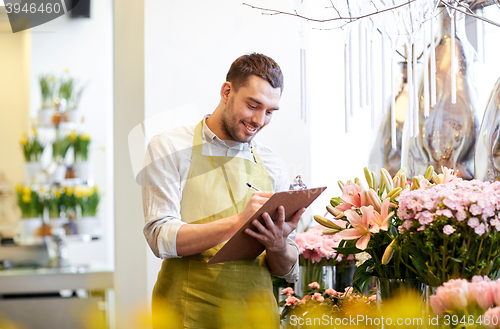 Image of florist man with clipboard at flower shop