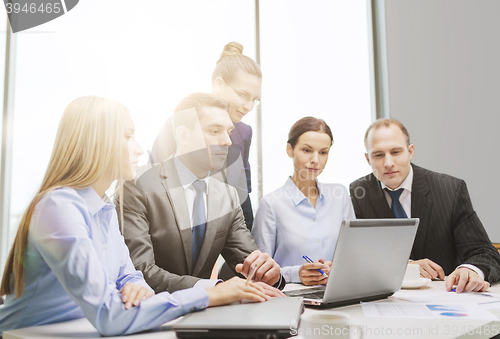 Image of business team with laptop having discussion