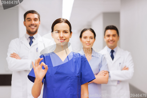 Image of group of medics at hospital showing ok hand sign