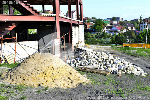 Image of Construction materials and waste on the background of building under construction