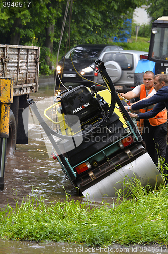 Image of RUSSIA - MAY 27, 2016: An unidentified man raises overturned tec