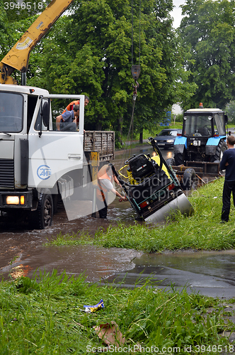 Image of RUSSIA - MAY 27, 2016: An unidentified man raises overturned tec