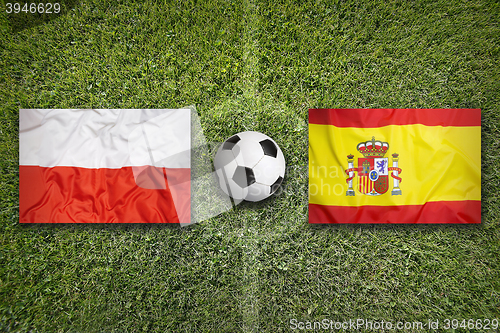 Image of Poland vs. Spain flags on soccer field
