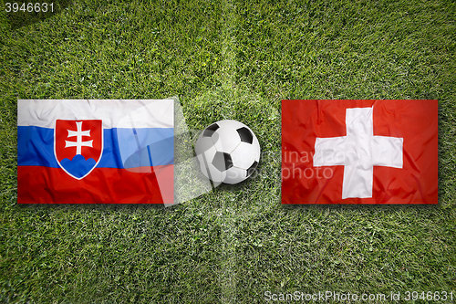 Image of Slovakia vs. Switzerland flags on soccer field