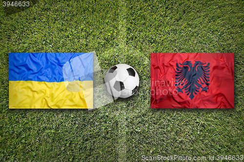 Image of Ukraine vs. Albania flags on soccer field