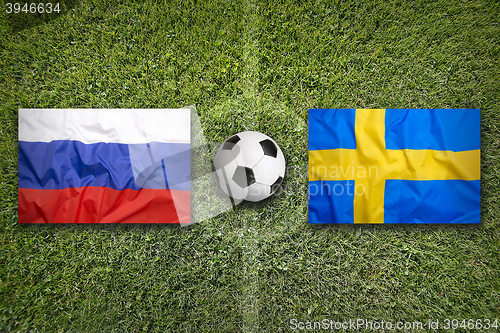 Image of Russia vs. Sweden flags on soccer field