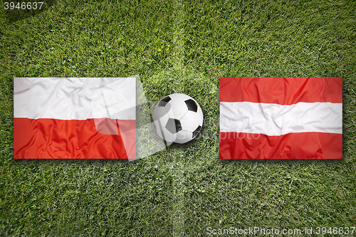 Image of Poland vs. Austria flags on soccer field
