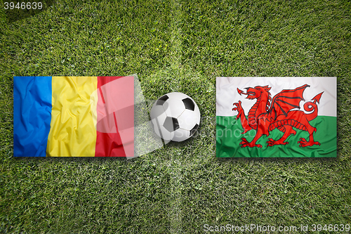 Image of Romania vs. Wales flags on soccer field
