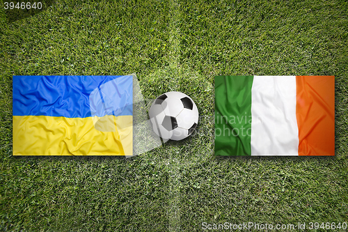 Image of Ukraine vs. Ireland flags on soccer field