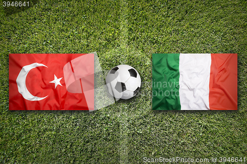 Image of Turkey vs. Italy flags on soccer field