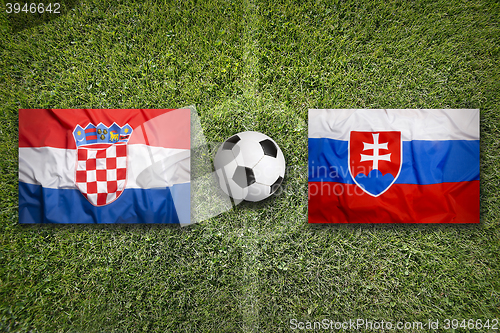 Image of Croatia vs. Slovakia flags on soccer field