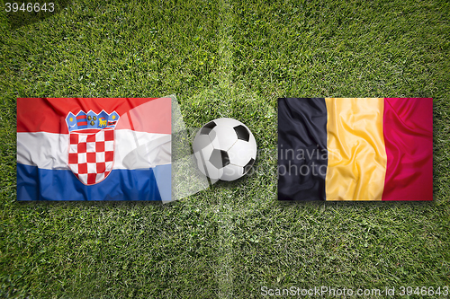 Image of Croatia vs. Belgium flags on soccer field