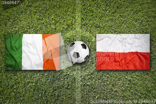 Image of Ireland vs. Poland flags on soccer field