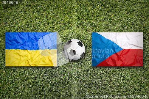 Image of Ukraine vs. Czech Republic flags on soccer field