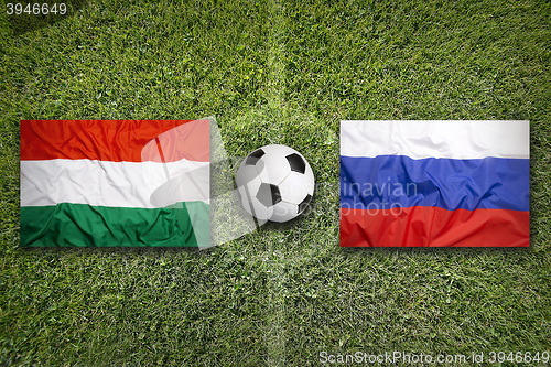 Image of Hungary vs. Russia flags on soccer field