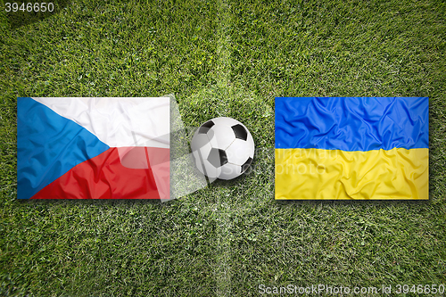 Image of Czech Republic vs. Ukraine flags on soccer field