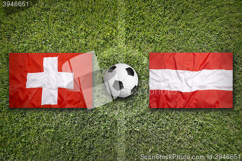 Image of Switzerland vs. Austria flags on soccer field