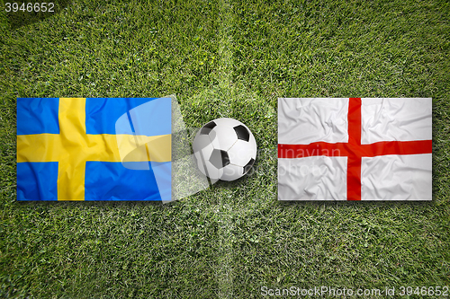 Image of Sweden vs. England flags on soccer field