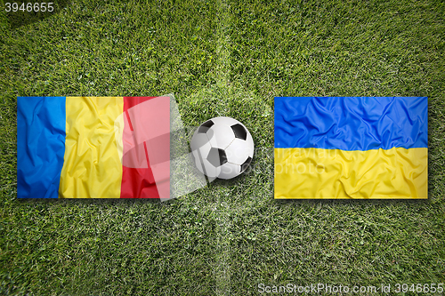 Image of Romania vs. Ukraine flags on soccer field