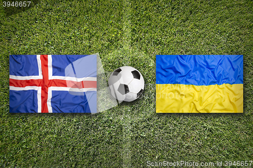 Image of Iceland vs. Ukraine flags on soccer field