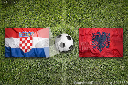 Image of Croatia vs. Albania flags on soccer field