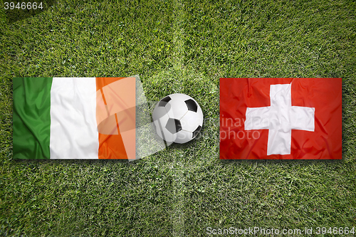 Image of Ireland vs. Switzerland flags on soccer field