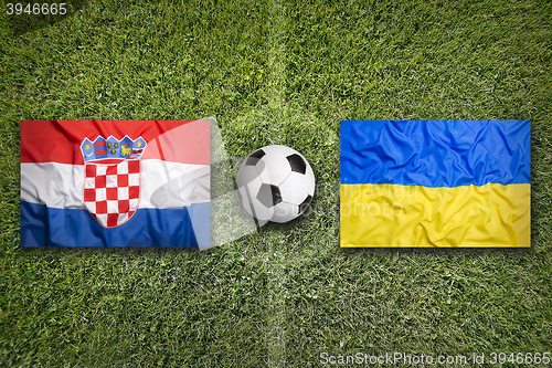 Image of Croatia vs. Ukraine flags on soccer field