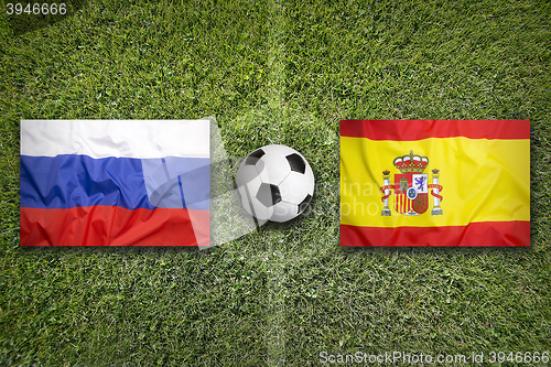 Image of Russia vs. Spain flags on soccer field