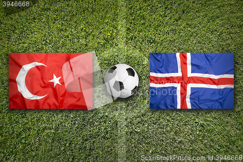 Image of Turkey vs. Iceland flags on soccer field