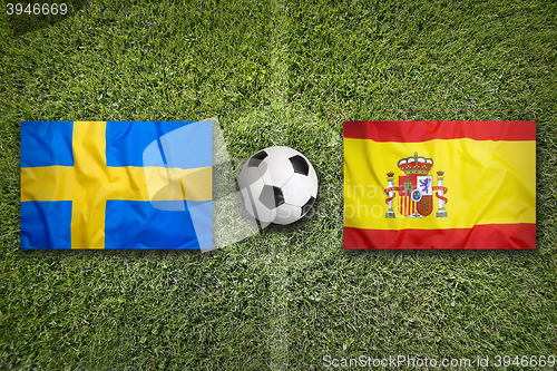 Image of Sweden vs. Spain flags on soccer field