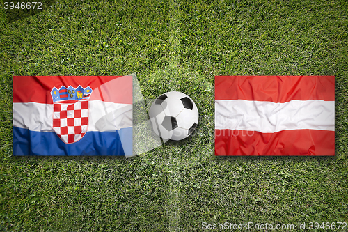 Image of Croatia vs. Austria flags on soccer field