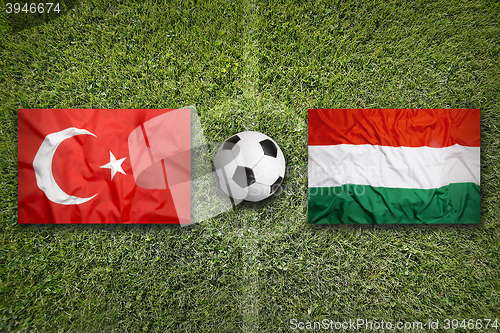 Image of Turkey vs. Hungary flags on soccer field