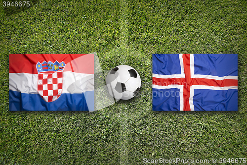 Image of Croatia vs. Iceland flags on soccer field
