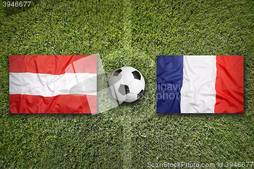 Image of Austria vs. France flags on soccer field