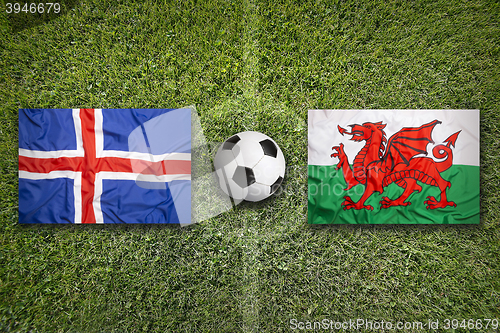 Image of Iceland vs. Wales flags on soccer field