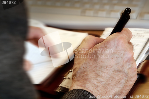 Image of man writing