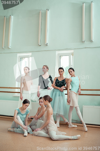 Image of The seven ballerinas at ballet bar