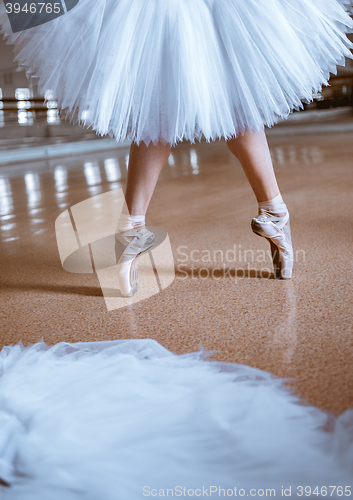 Image of The close-up feet of young ballerina in pointe shoes