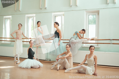 Image of The seven ballerinas at ballet bar