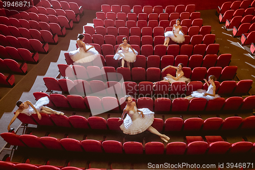 Image of Ballerinas sitting in the empty auditorium theater